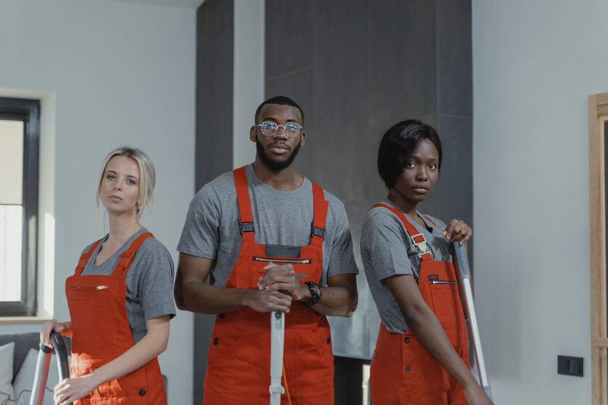 Andre Whitfield with two of his technicians in uniform