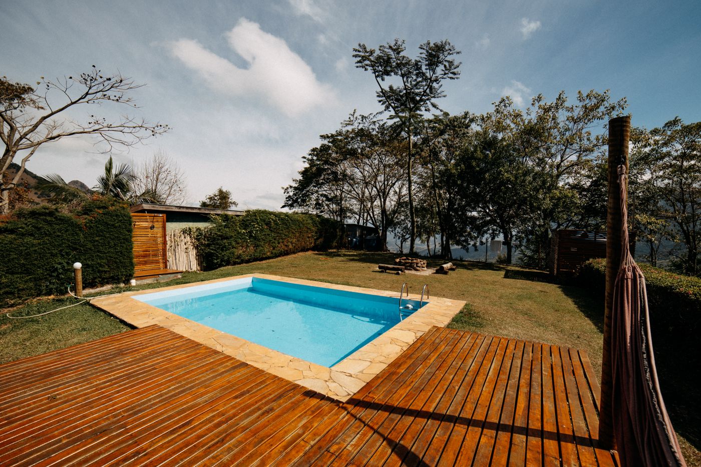 Stained wood pool deck in a backyard