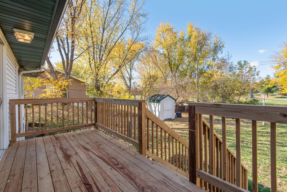 Wood deck with railings and stairs in autumn