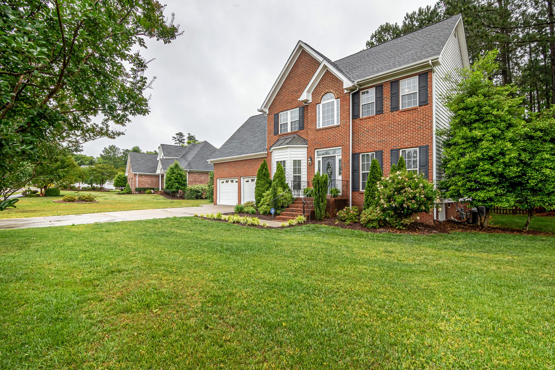 Brick colonial home with a thick, even front lawn