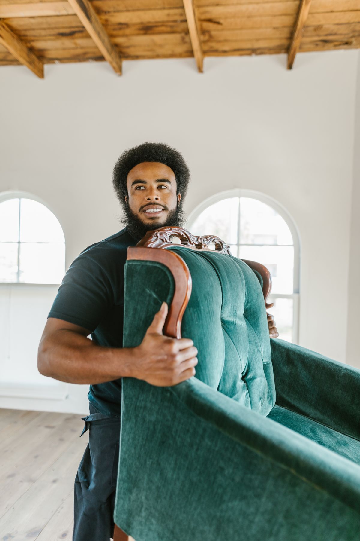 Two Bulldogs co-founder smiling while carrying a green armchair