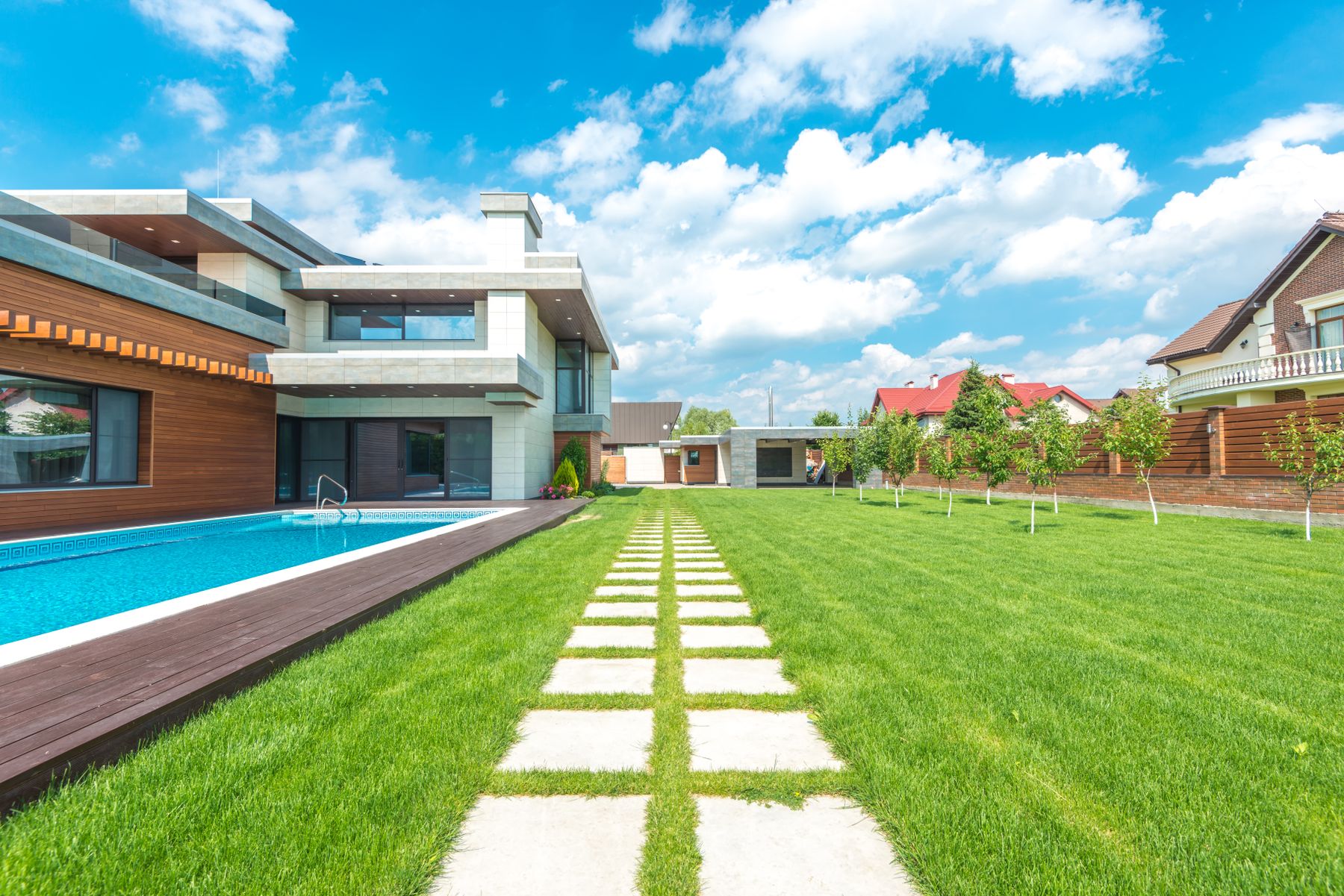 Long pool beside a lawn with a stepping-stone path