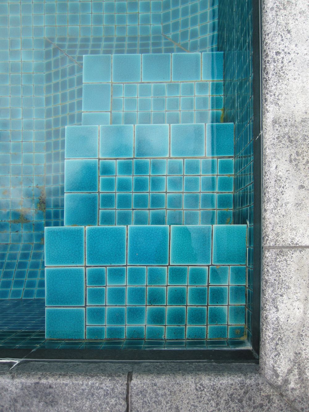 Blue mosaic tile on pool steps
