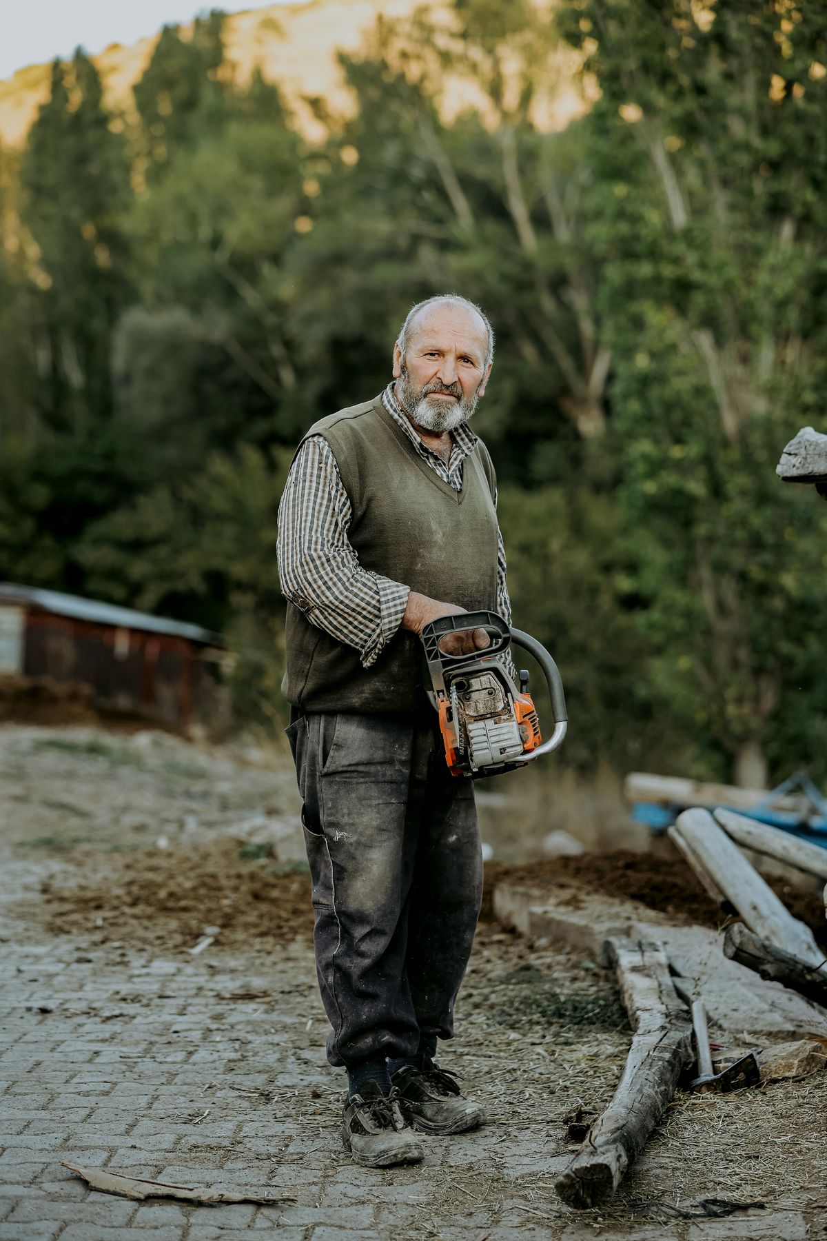 Sam holding a chainsaw in a work yard after a removal